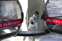 Senior Director Mountain Operations Diran Sudaholc "christens" the Quicksilver Gondola by breaking a bottle of champagne on it on Friday Dec. 18 during the grand opening of Quicksilver Gondola and Miners Camp. (Jake Shane/Park Record)